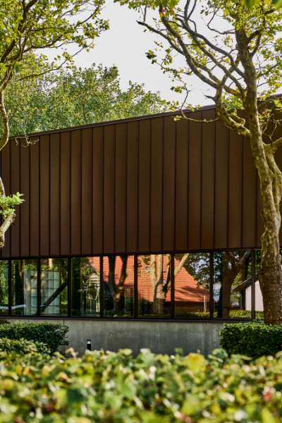New sports hall in the “forest” wrapped in acorn-brown steel profiles, Risskov Efterskole, Tretommervej 31A, 8240 Risskov, Denmark